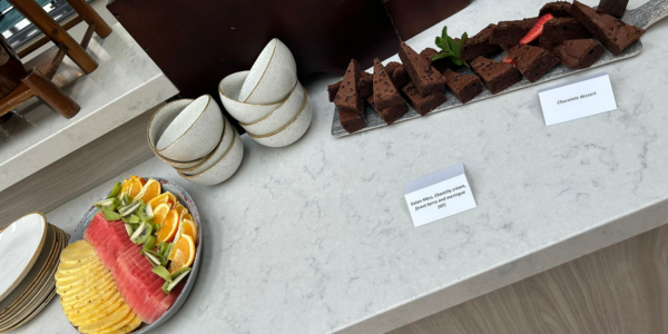 Professionally prepared serving platters of chocolate brownies and fresh fruit, ready for event attendees to serve themselves.